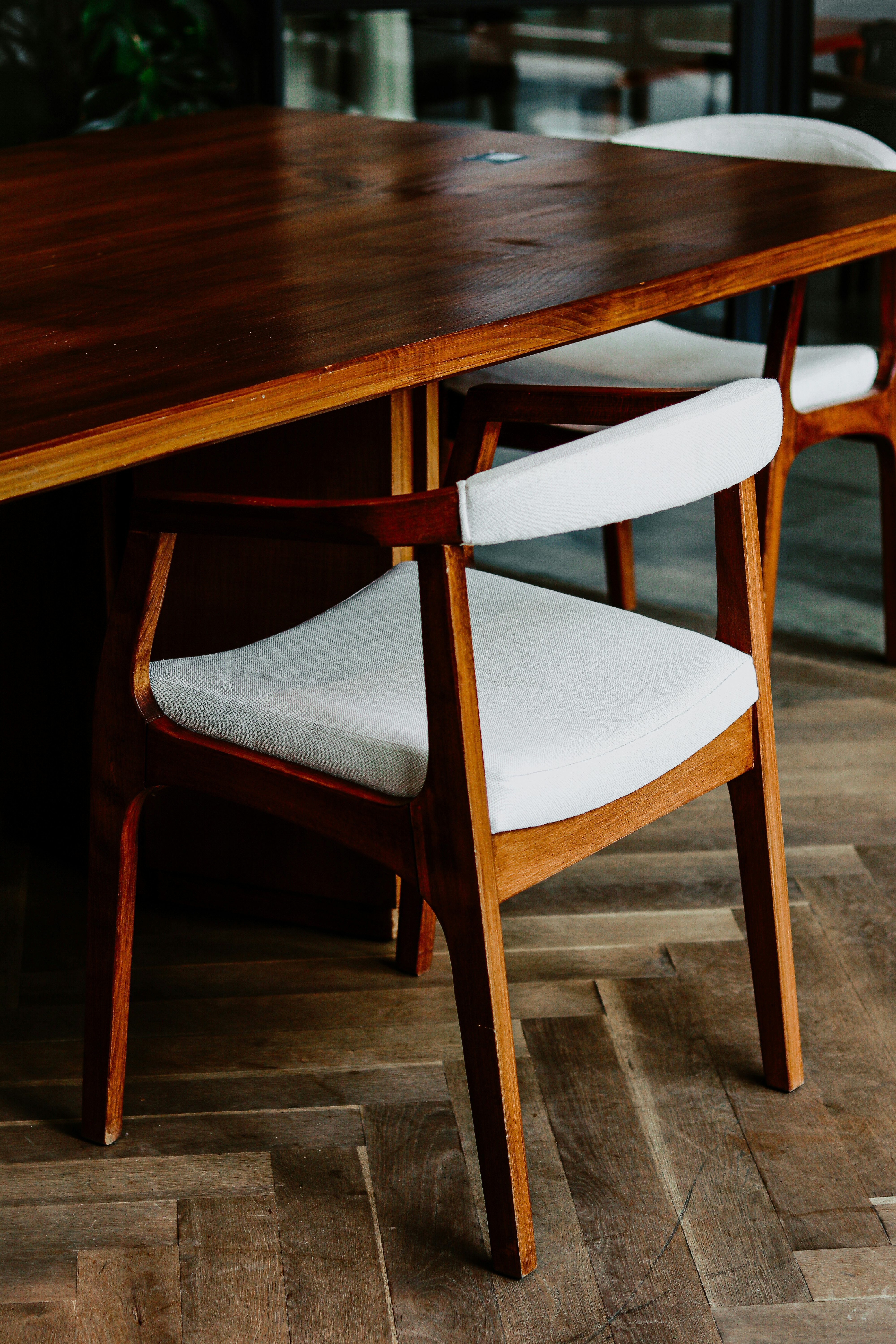 brown wooden table with white and brown chair